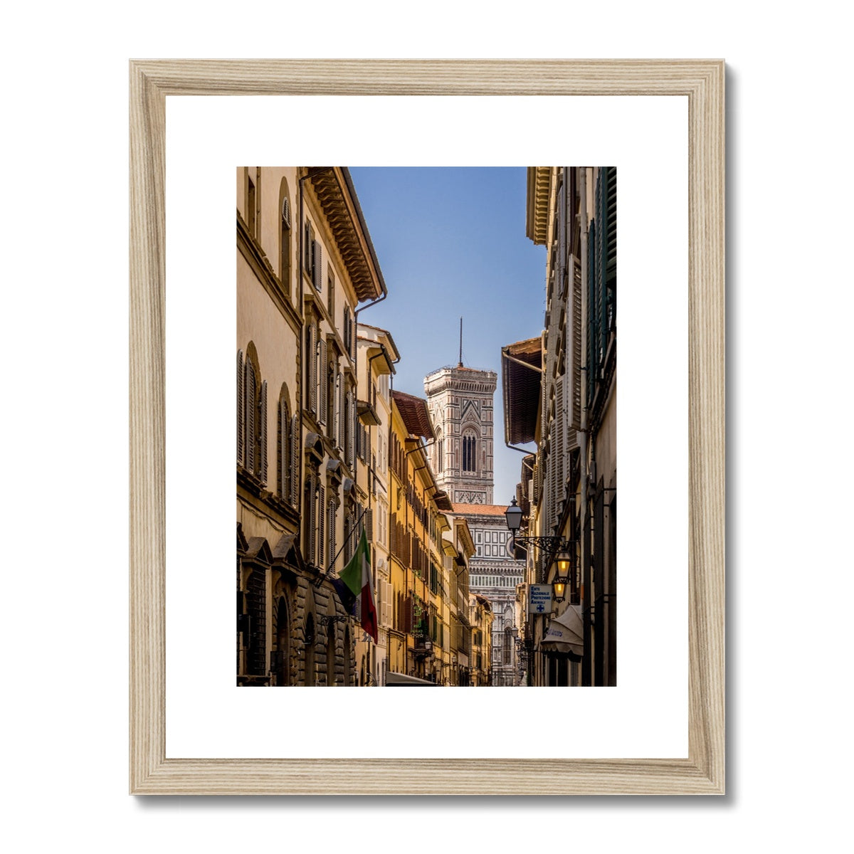 Giotto's Campanile glimpsed between buildings in the city of Florence, Italy. Framed & Mounted Print
