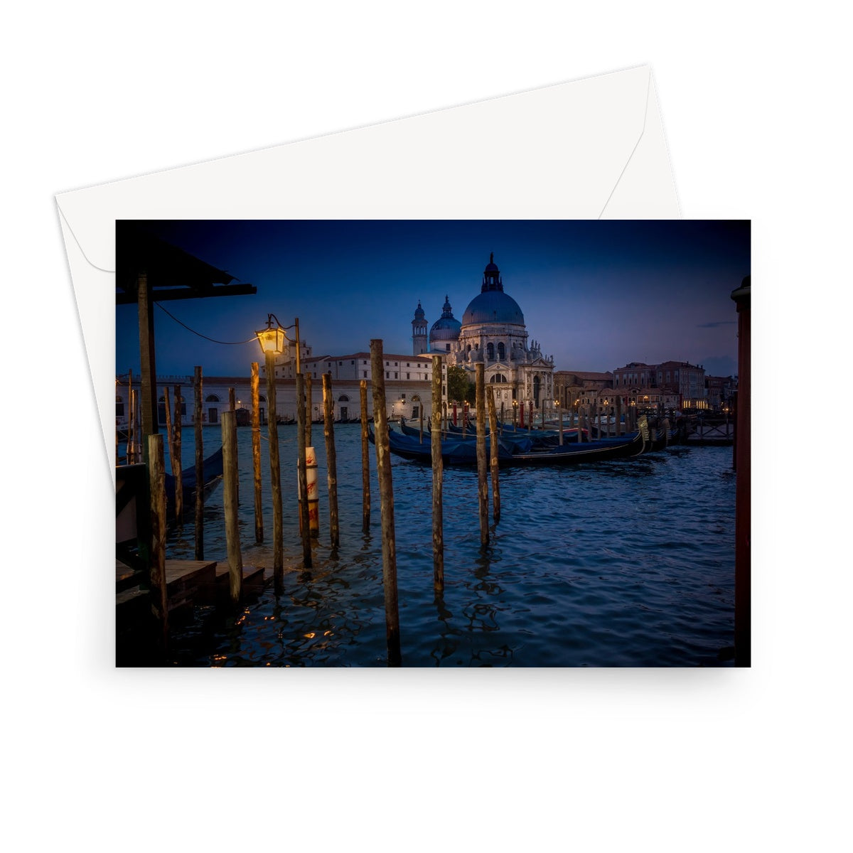 Gondolas moored for the night on the Grand Canal with the church of Santa Maria della Salute in the background. Venice, Italy. - Greeting Card