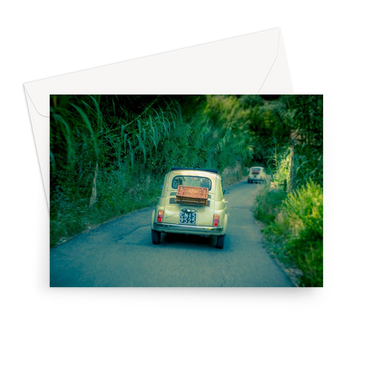 Classic Fiat 500 cars driving on a road in Florence, Italy.  Greeting Card