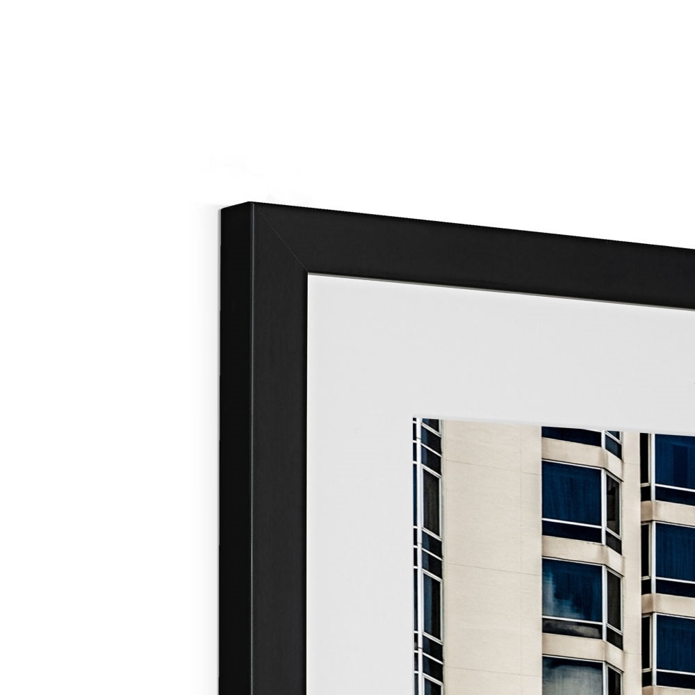 Symmetrical pattern of windows on contemporary skyscraper Framed & Mounted Print