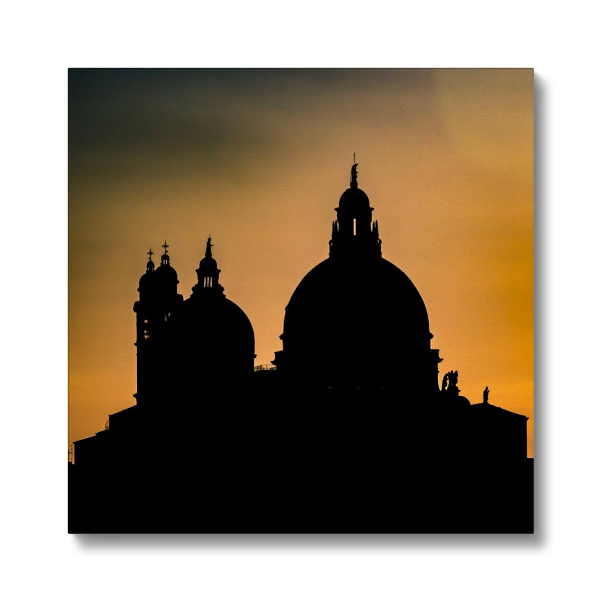 Silhouette of Santa Maria della Salute on the Grand Canal in Venice against a golden sky at sunset. Italy. Canvas