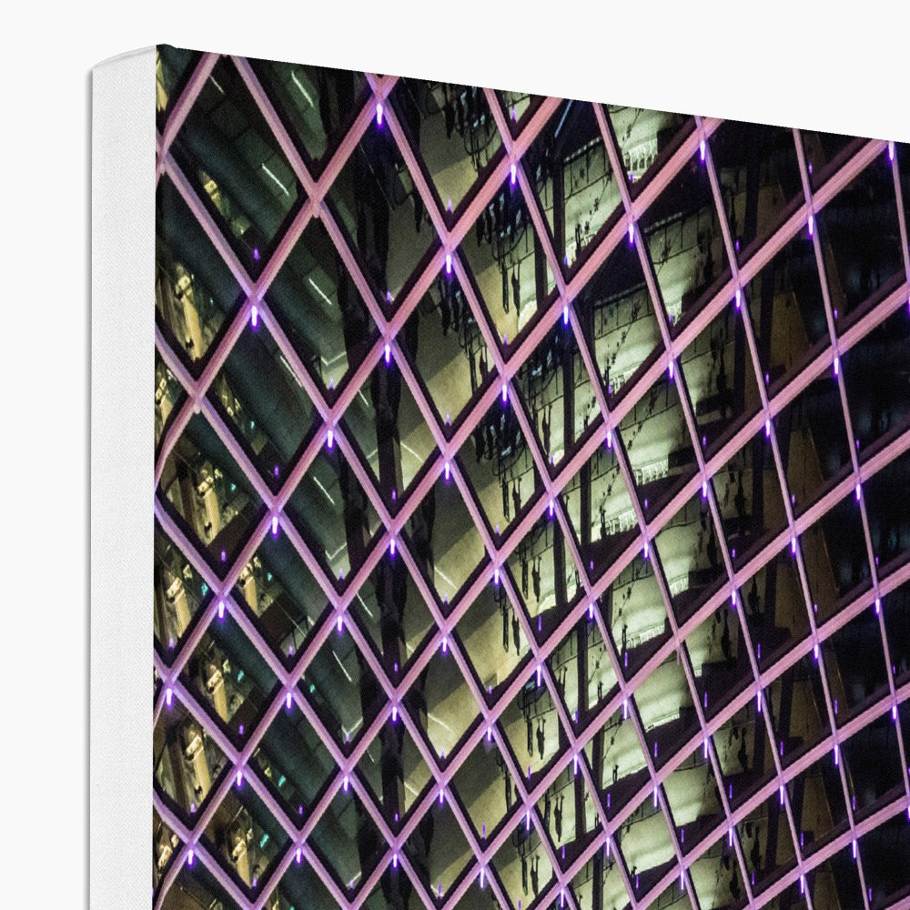 Illuminated grid pattern on a glass ceiling captured at night Canvas