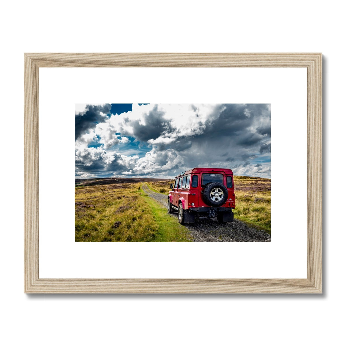 Red Land Rover Defender 110 4WD car navigating a Green Lane track, North Yorkshire Moors, UK. Framed & Mounted Print