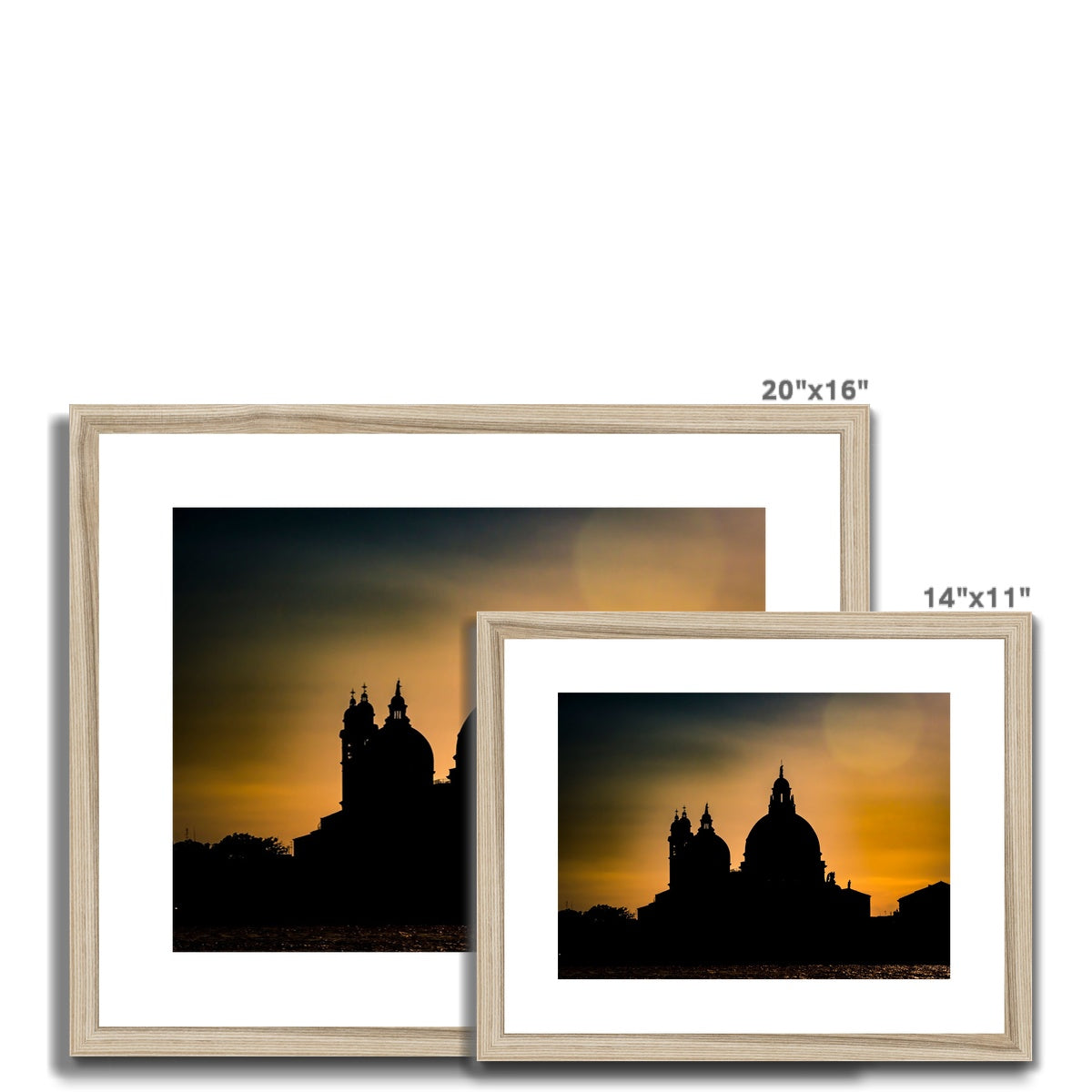Silhouette of Santa Maria della Salute on the Grand Canal in Venice against a golden sky at sunset. Italy. Framed & Mounted Print