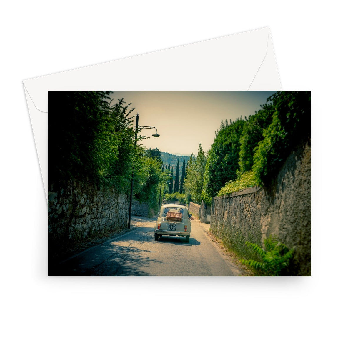 Classic Fiat 500 car driving on a road in Florence, Italy. Greeting Card