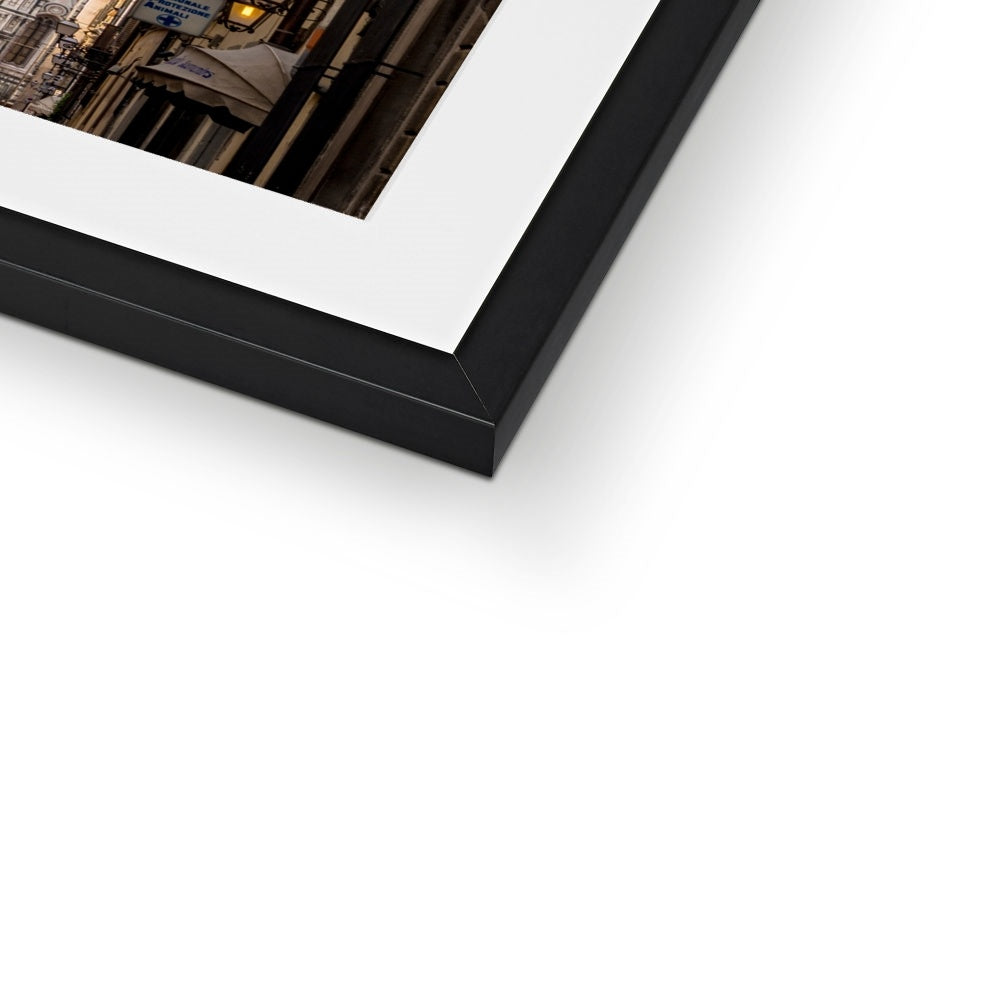 Giotto's Campanile glimpsed between buildings in the city of Florence, Italy. Framed & Mounted Print