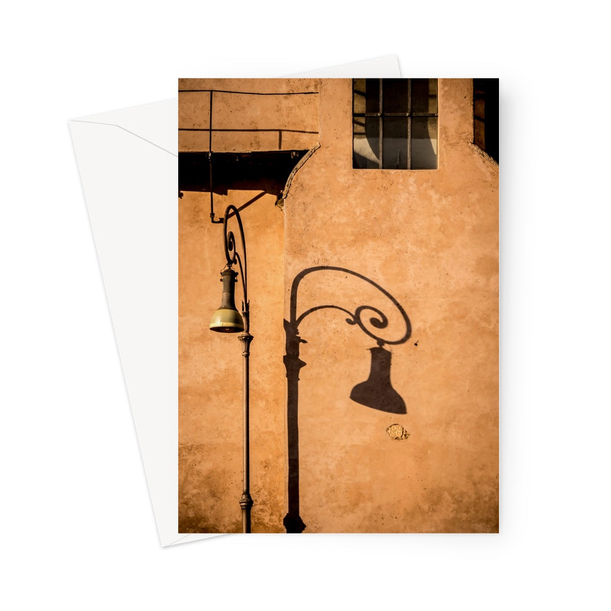 Street lamp and shadow on rendered building wall, Rome, Italy. Greeting Card