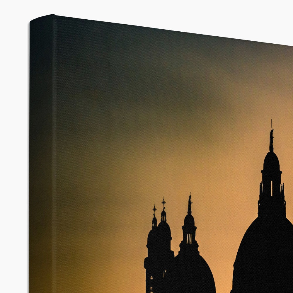 Silhouette of Santa Maria della Salute on the Grand Canal in Venice against a golden sky at sunset. Italy. Canvas