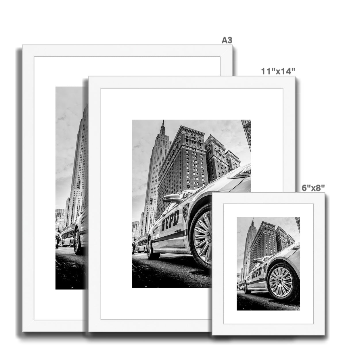 NYPD patrol car with Empire State Building on W 34th St, New York City, USA. Framed & Mounted Print