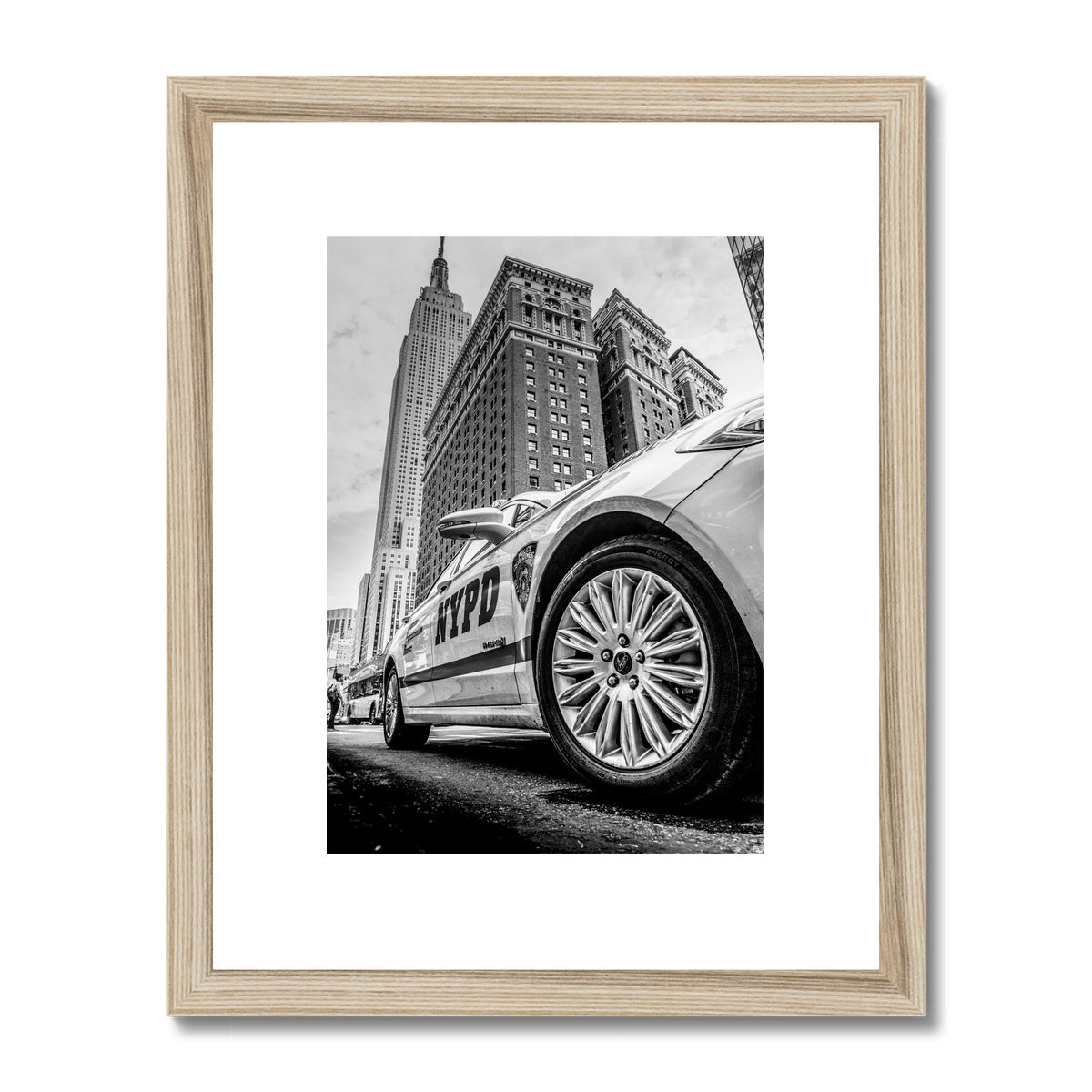 NYPD patrol car with Empire State Building on W 34th St, New York City, USA. Framed & Mounted Print