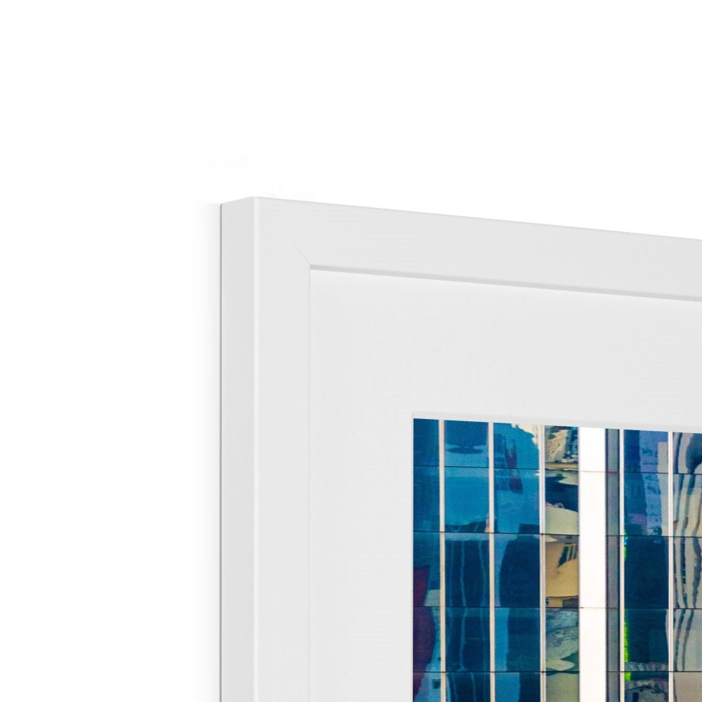 Urban reflections dance across a skyscraper's glazed facade Framed & Mounted Print