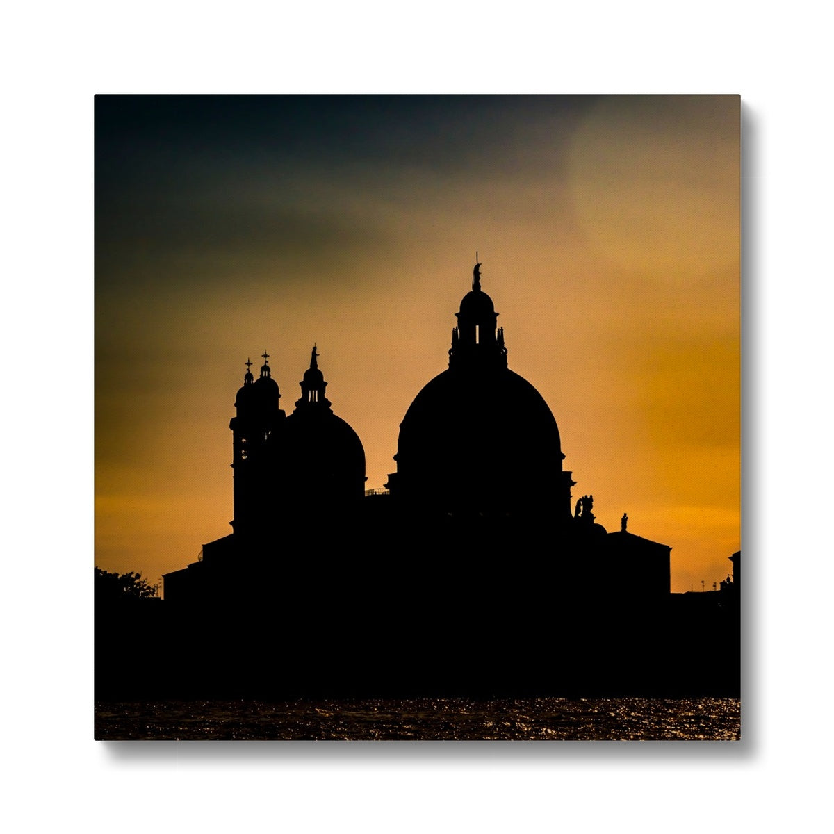 Silhouette of Santa Maria della Salute on the Grand Canal in Venice against a golden sky at sunset. Italy. Canvas