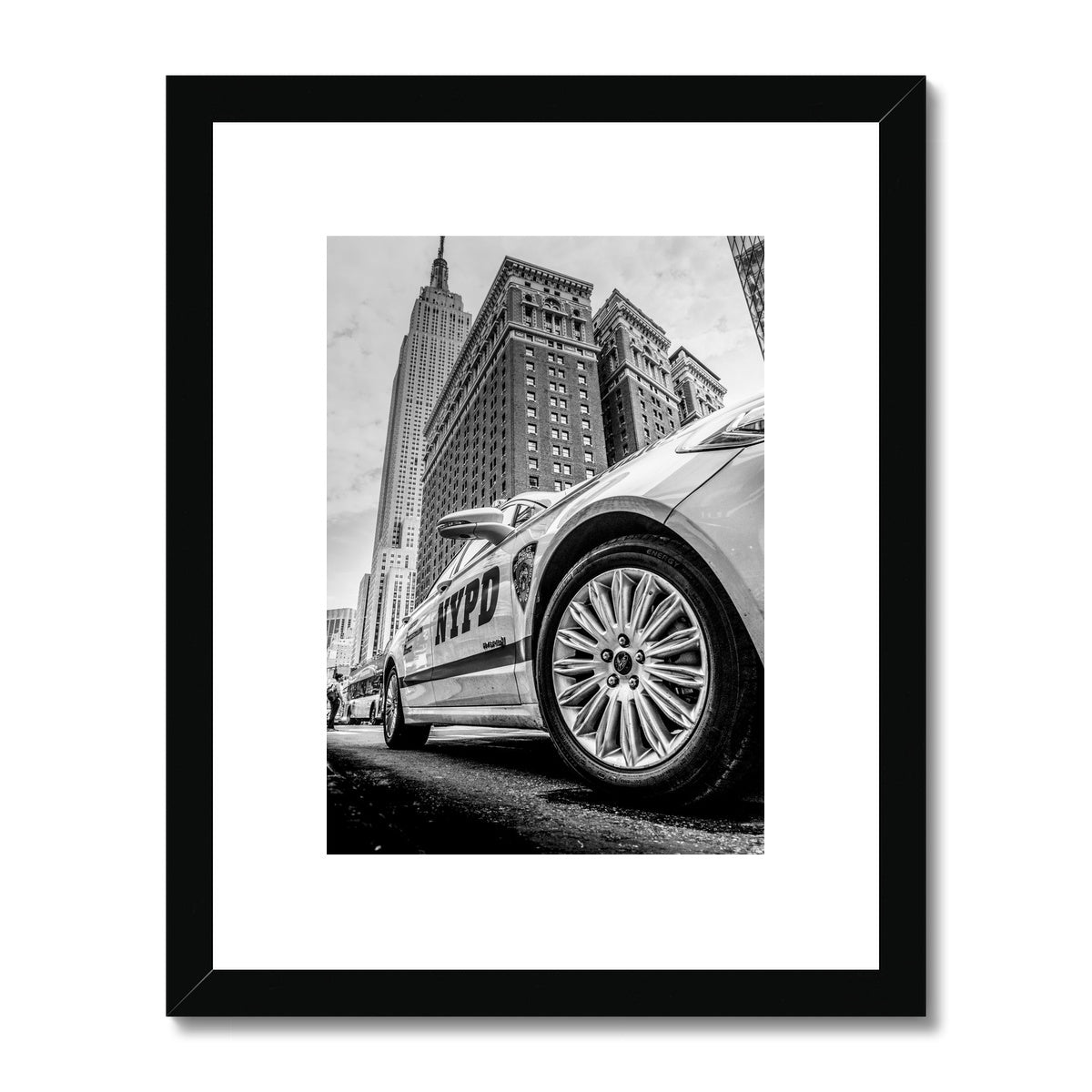 NYPD patrol car with Empire State Building on W 34th St, New York City, USA. Framed & Mounted Print