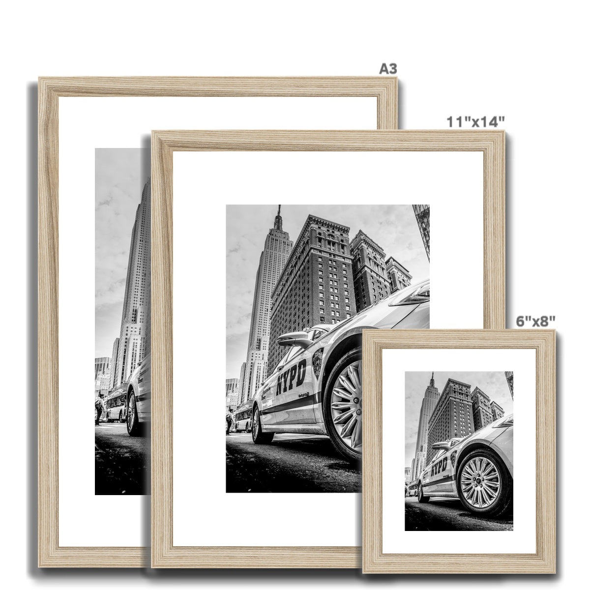 NYPD patrol car with Empire State Building on W 34th St, New York City, USA. Framed & Mounted Print