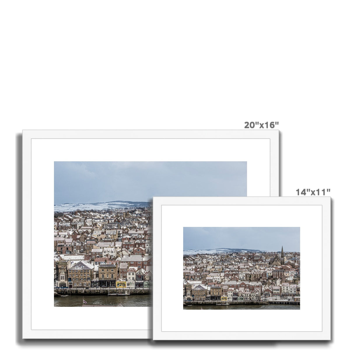 View of Whitby town centre in snow from St Mary's Church, Whitby, UK. Framed & Mounted Print