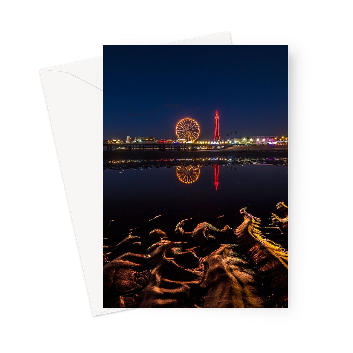 Blackpool Tower and Central Pier at night, with reflection of illuminations in water on the beach  UK. Greeting Card