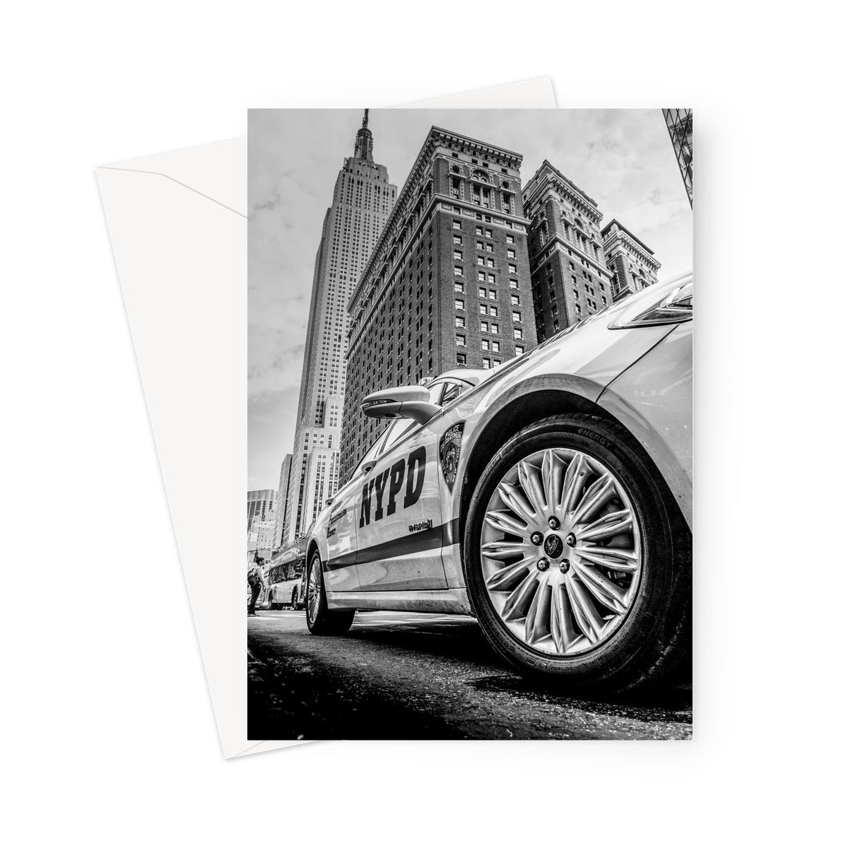 NYPD patrol car with Empire State Building on W 34th St, New York City, USA. Greeting Card