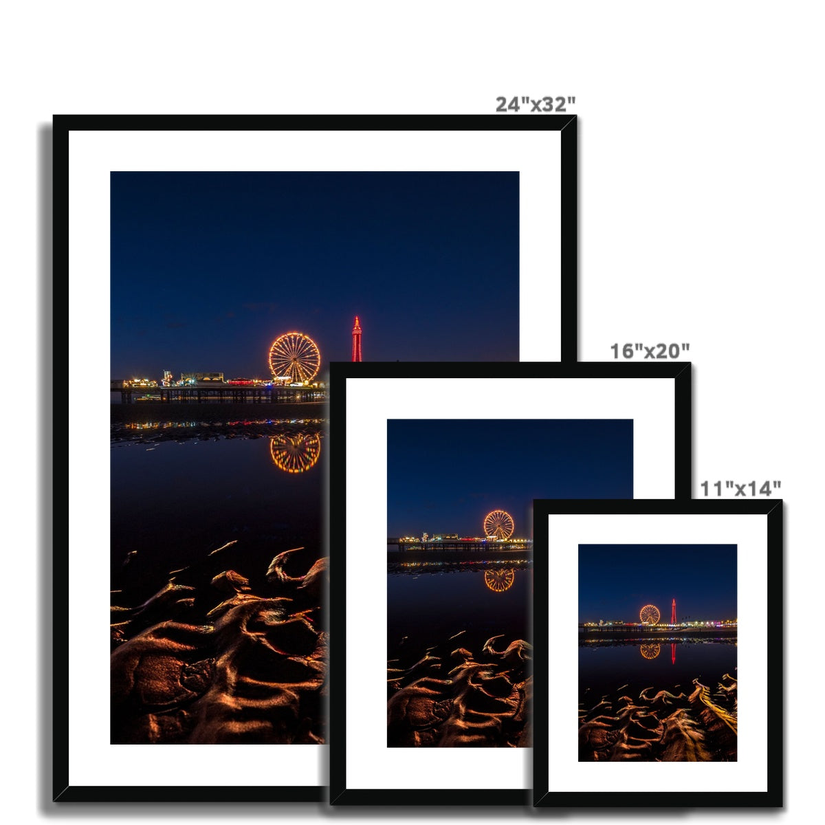 Blackpool Tower and Central Pier at night, with reflection of illuminations in water on the beach  UK. Framed & Mounted Print