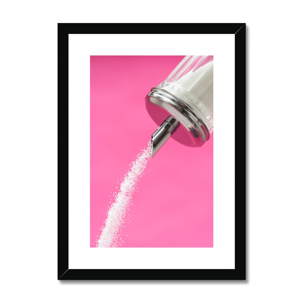 Sugar dispenser pouring against pink background Framed & Mounted Print