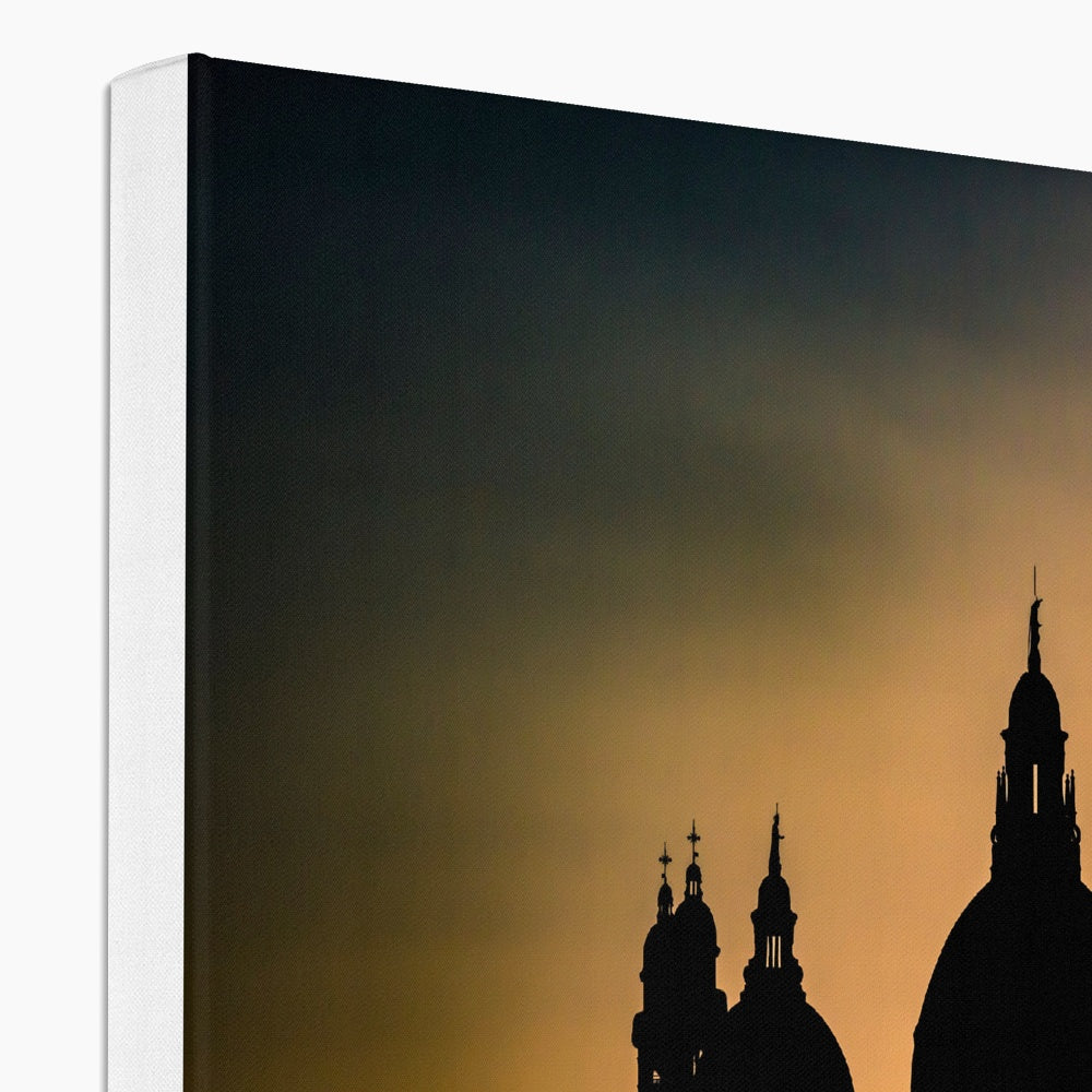 Silhouette of Santa Maria della Salute on the Grand Canal in Venice against a golden sky at sunset. Italy. Canvas