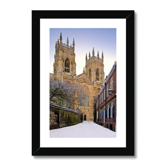 York Minster in the snow seen from Precentors Court. York, UK. Framed & Mounted Print