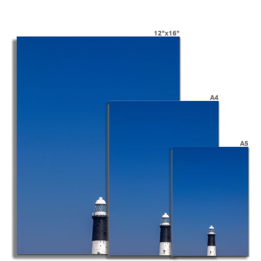 Top of a lighthouse against blue sky Fine Art Print
