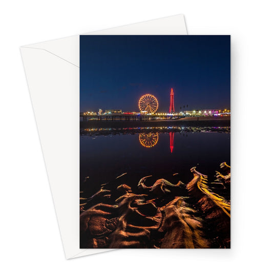 Blackpool Tower and Central Pier at night, with reflection of illuminations in water on the beach  UK. Greeting Card