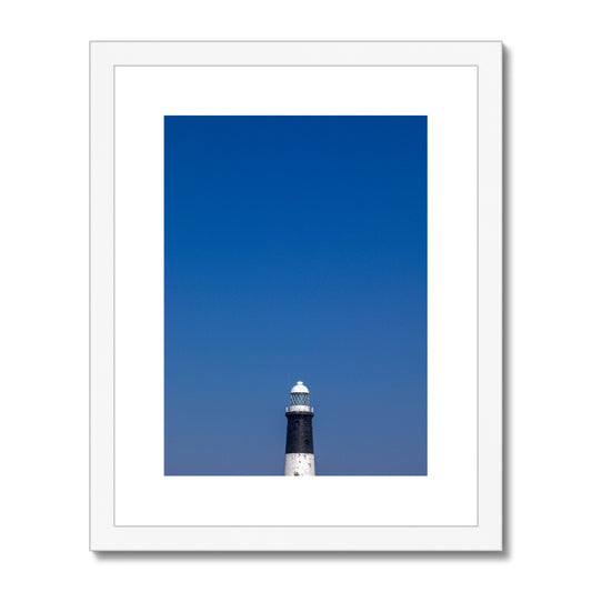 Top of a lighthouse against blue sky Framed & Mounted Print