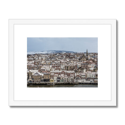 View of Whitby town centre in snow from St Mary's Church, Whitby, UK. Framed & Mounted Print