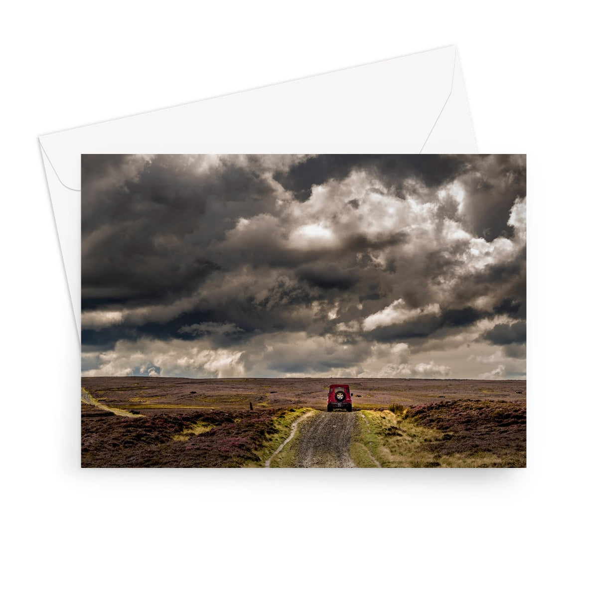 Red Land Rover Defender 110 4WD car on a Green Lane track, North Yorkshire Moors, UK. Greeting Card