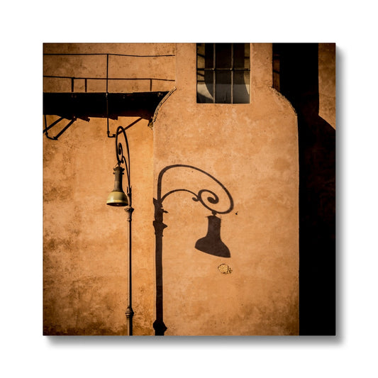 Street lamp and shadow on rendered building wall, Rome, Italy. Canvas