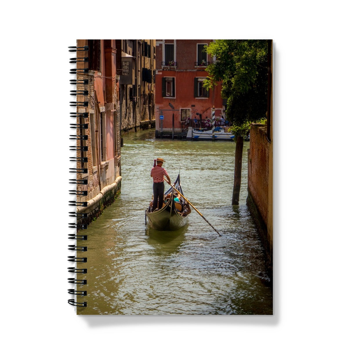 Gondola with gondolier wearing a traditional boater hat and striped top on a  canal in Venice. Italy. Notebook