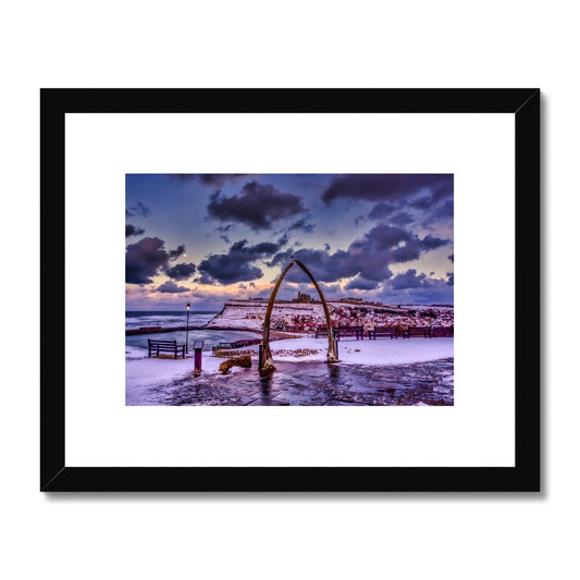 Whalebone Arch and view of Whitby Abbey in snow, Whitby, UK. Framed & Mounted Print