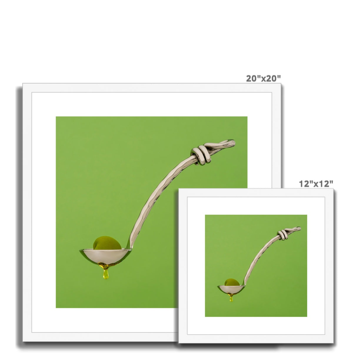 Single green olive on spoon with oil dripping. Framed & Mounted Print