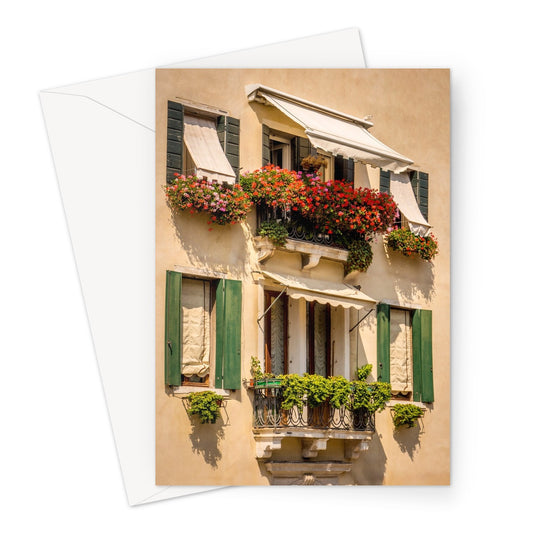 Traditional canal-side cream-rendered house with shuttered windows and window boxes. Venice. Italy. Greeting Card