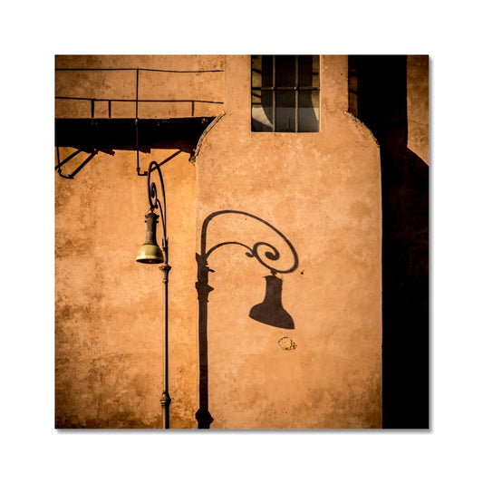 Street lamp and shadow on rendered building wall, Rome, Italy. Fine Art Print
