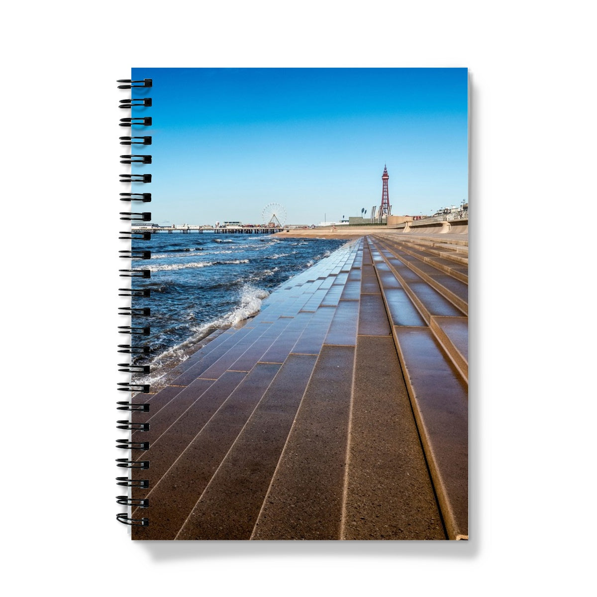 Blackpool's stone stepped sea defences with Blackpool Tower and Central Pier in the distance, Blackpool, UK. Notebook