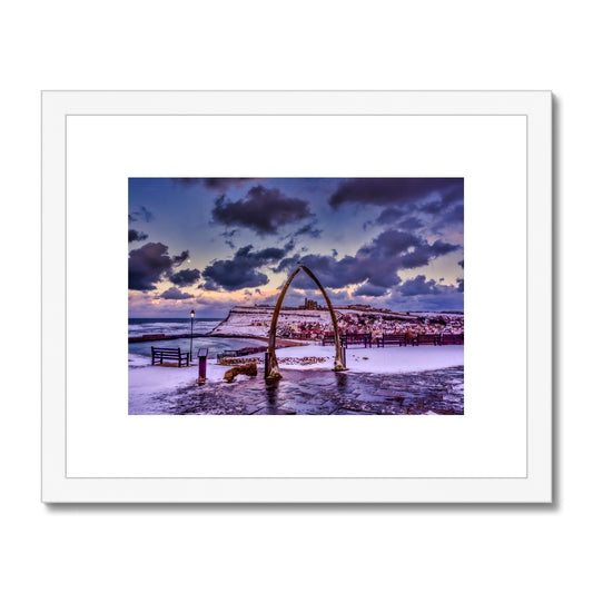 Whalebone Arch and view of Whitby Abbey in snow, Whitby, UK. Framed & Mounted Print