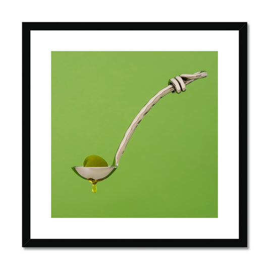 Single green olive on spoon with oil dripping. Framed & Mounted Print