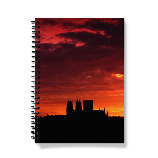 York Minster silhouetted against an orange sky at sunrise Notebook