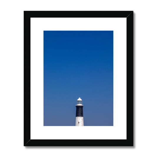 Top of a lighthouse against blue sky Framed & Mounted Print