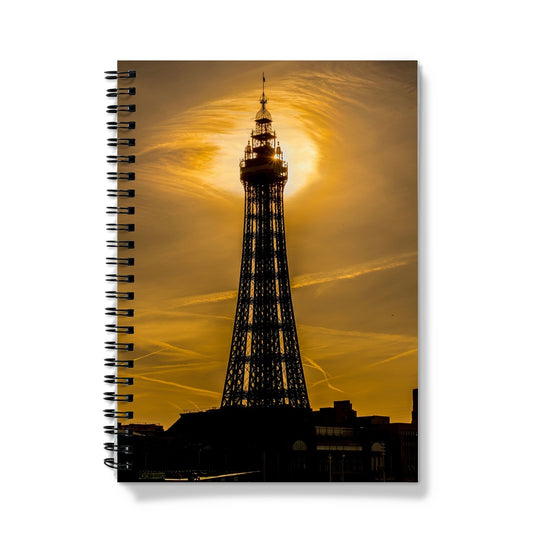 Blackpool Tower silhouetted against morning sunlight. UK. Notebook