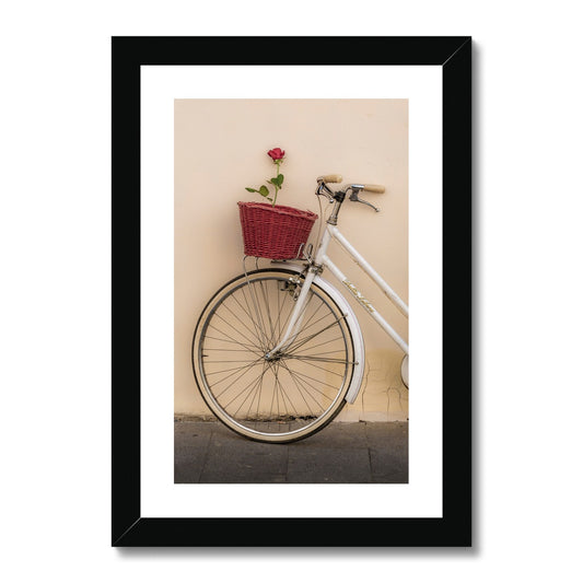 White bicycle parked against a  rendered wall with a red rose in its basket, Rome, Italy. Framed & Mounted Print