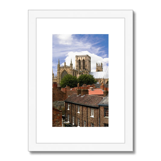 York Minster towering over York's historic rooftops. York. North Yorkshire. UK Framed & Mounted Print