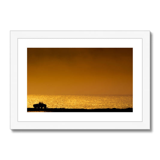 Silhouette of jeep on beach at sunset Framed & Mounted Print