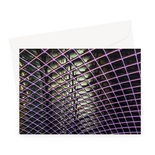 Illuminated grid pattern on a glass ceiling captured at night Greeting Card