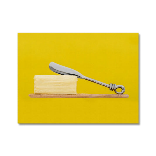 Homemade butter on wooden paddle with butter knife and yellow background. Canvas