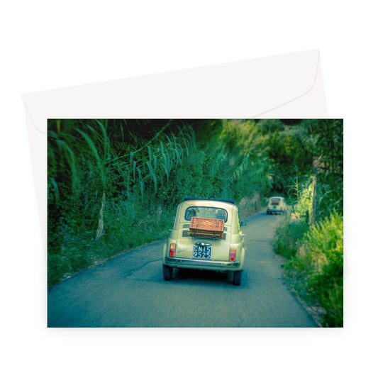 Classic Fiat 500 cars driving on a road in Florence, Italy.  Greeting Card
