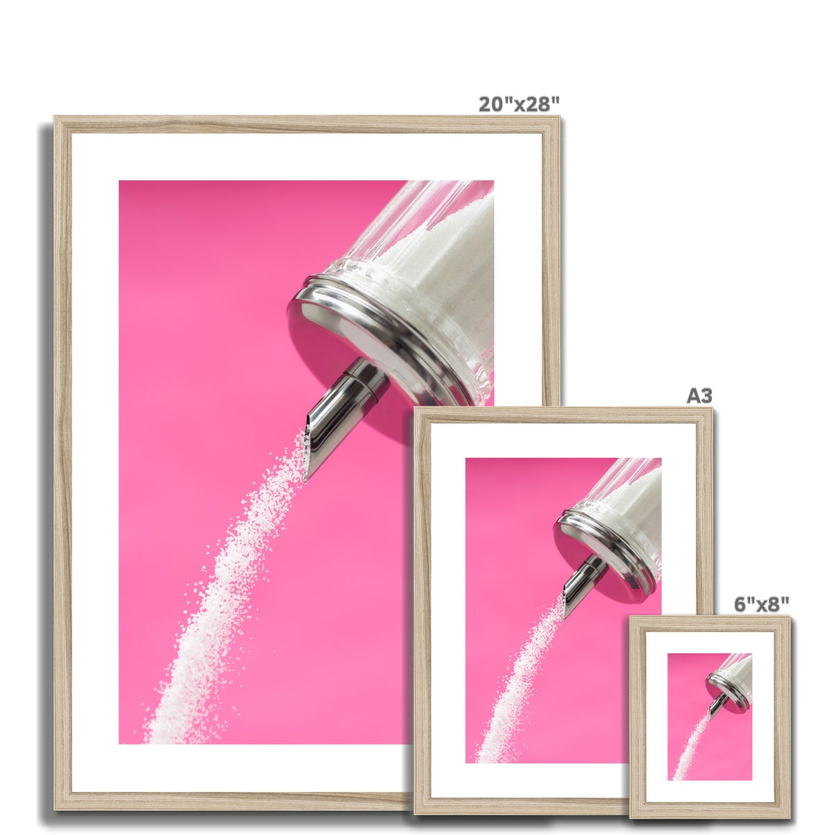 Sugar dispenser pouring against pink background Framed & Mounted Print