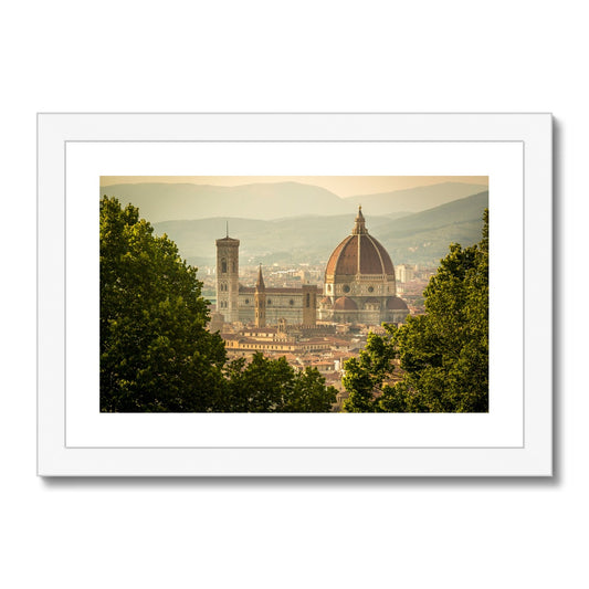 The south façade of Florence Cathedral glimpsed through the trees of San Miniato al Monte.  Italy. Framed & Mounted Print